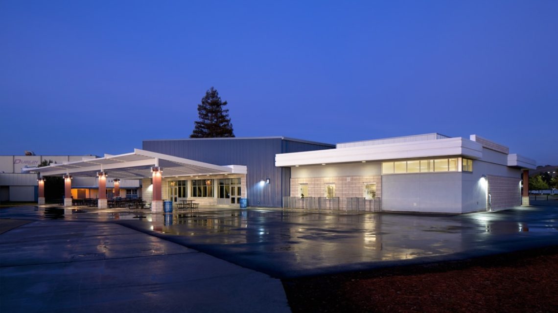 Student Union at Dawn from the Northwest withthe building's exterior surfaces and interior space illuminated