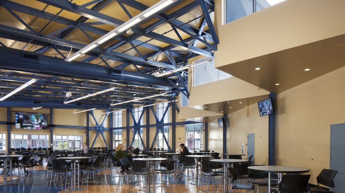 a view from the interior space looking towards the windows and the seating area with models
